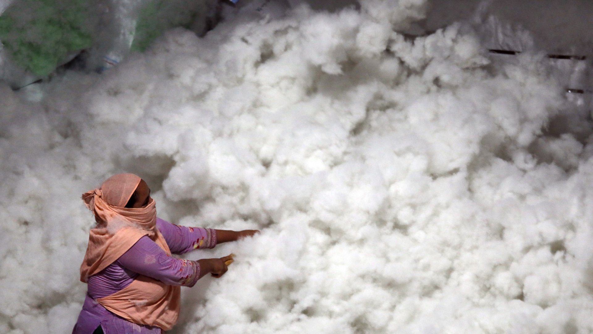 Employees operate machinery to transform recycled plastic waste into synthetic fiber at a manufacturing facility in Kamrangirchar, Dhaka, Bangladesh, in June 2026. The recycled material is processed, cleaned, and converted into soft polyester-like fiber that is later used in the production of dolls, stuffed toys, pillows, mattresses, and other consumer goods. The industry provides employment opportunities while contributing to the reuse of plastic waste in Bangladesh's expanding recycling sector. (Photo by Sony Ramani/NurPhoto)NO USE FRANCE