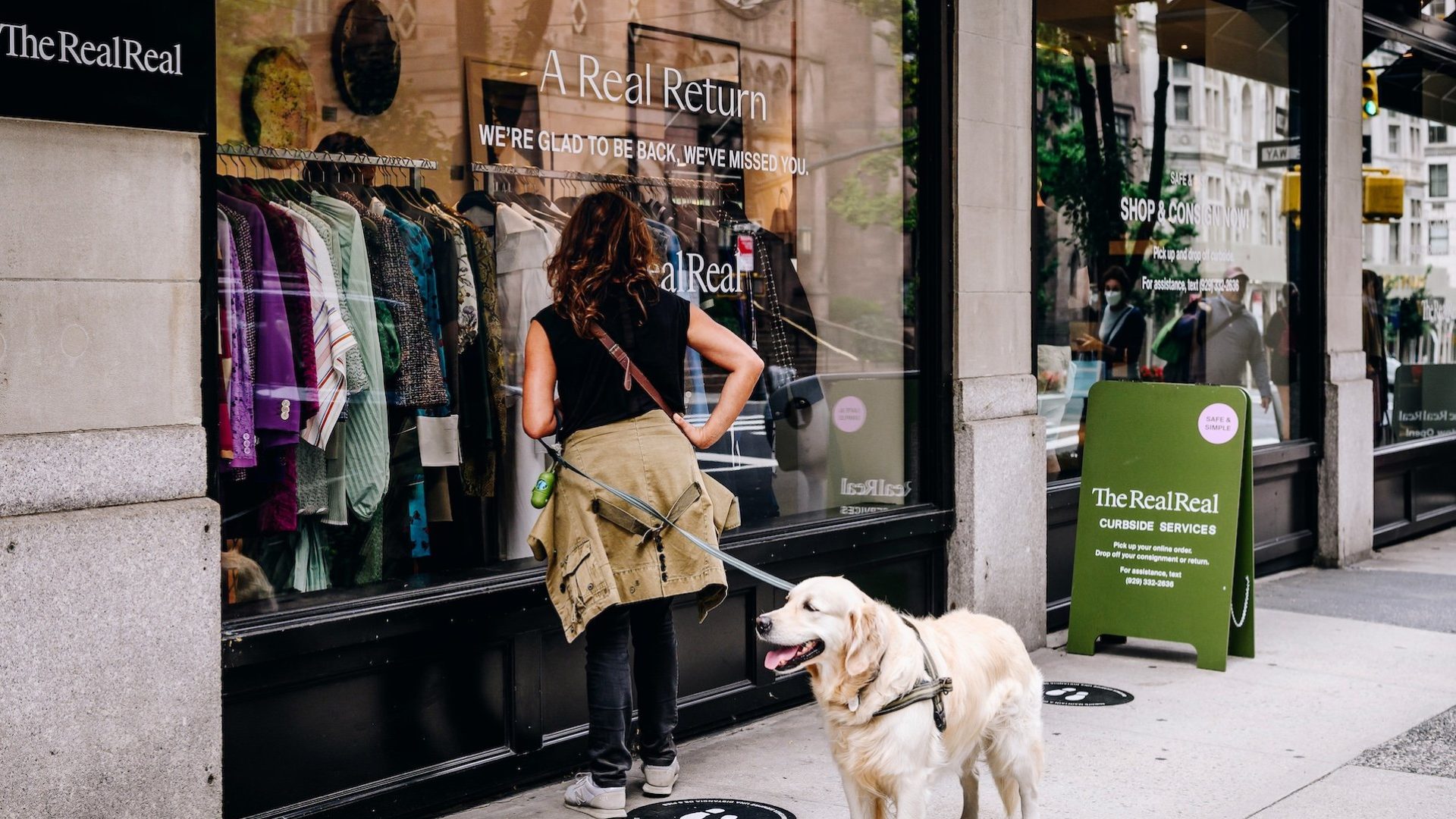 A customer waits to enter The RealReal Inc. store on Madison Avenue in New York, U.S., on Saturday, Sept. 26, 2020. The pandemic has battered New York City businesses, with almost 6,000 closures, a jump of about 40% in bankruptcy filings across the region and shuttered storefronts in the business districts of all five boroughs. Photographer: Nina Westervelt/Bloomberg